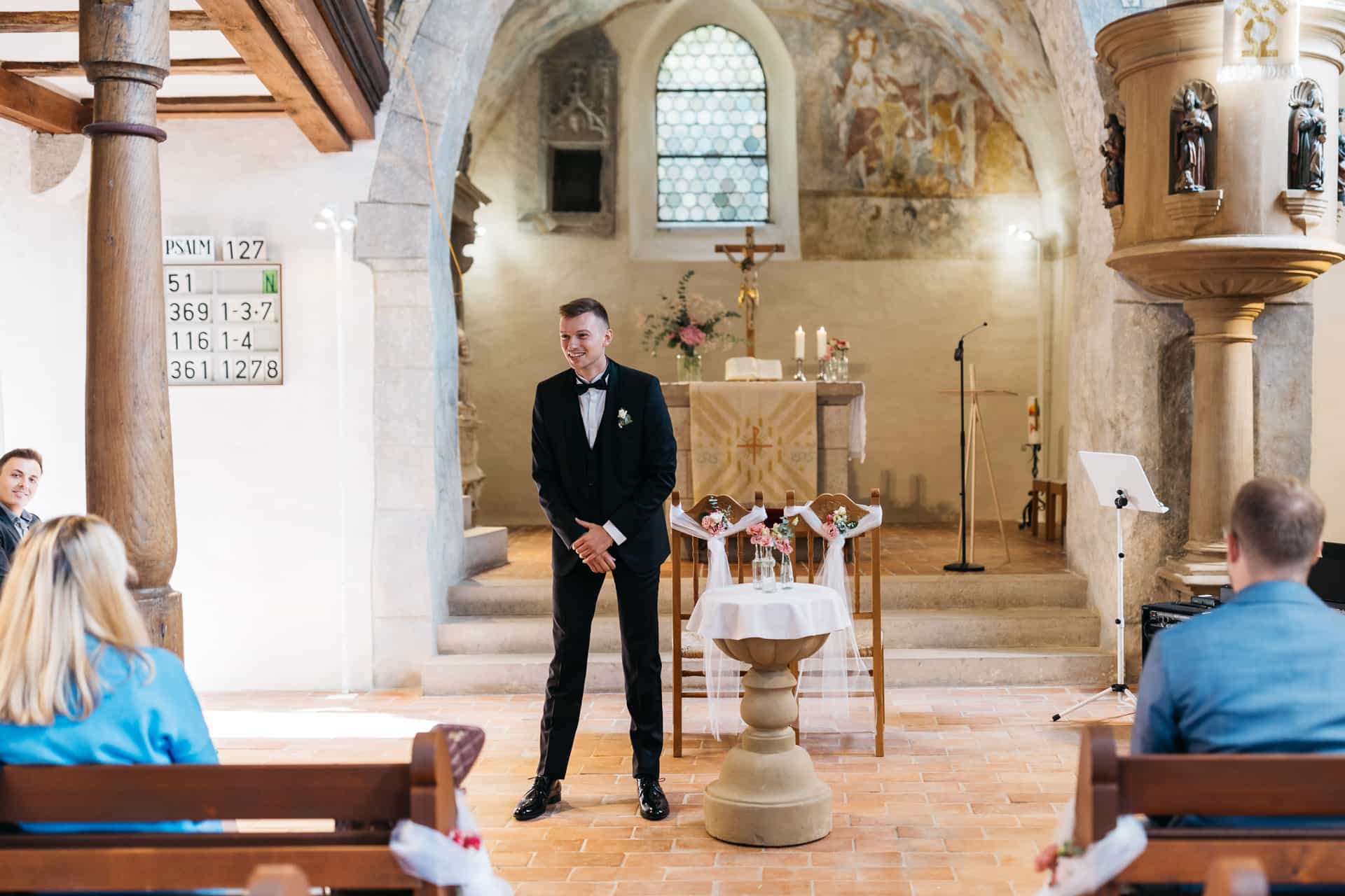 Bräutigam wartet vor dem Altar auf die Braut