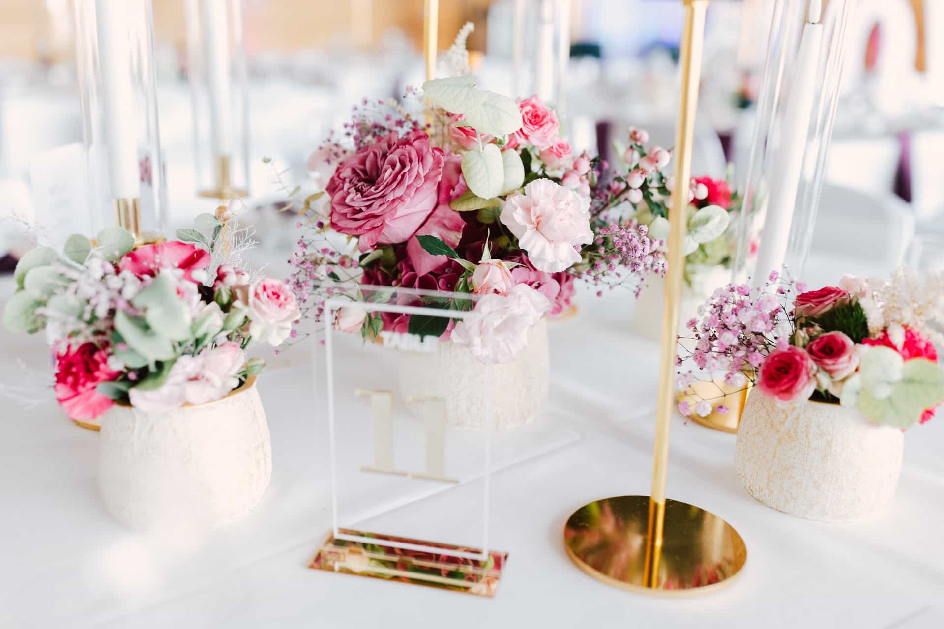 Hohe Kerzenleuchter und rosa Blumen auf der Festtafel